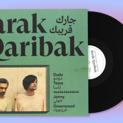 The Jarak Quaribak album cover. The album is green with black writing on top. There is a picture of Dudu Tassa and Johnny Greenwood at the bottom.